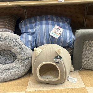 Pet beds on display, one has little cat ears on top